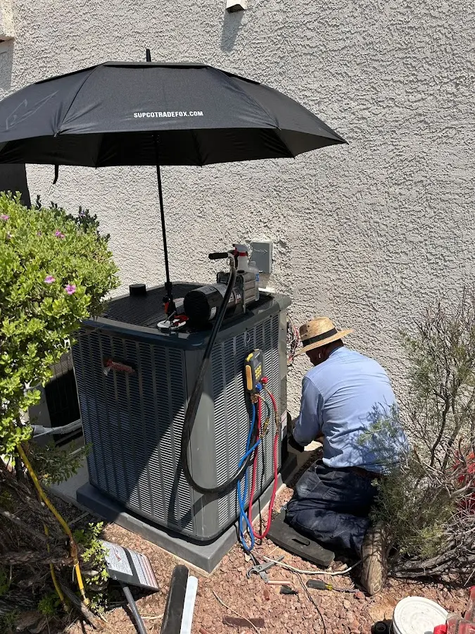 HVAC technician performing outdoor AC maintenance in Green Lake